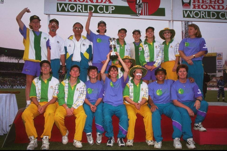 The victorious Australia squad pose with the World Cup trophy