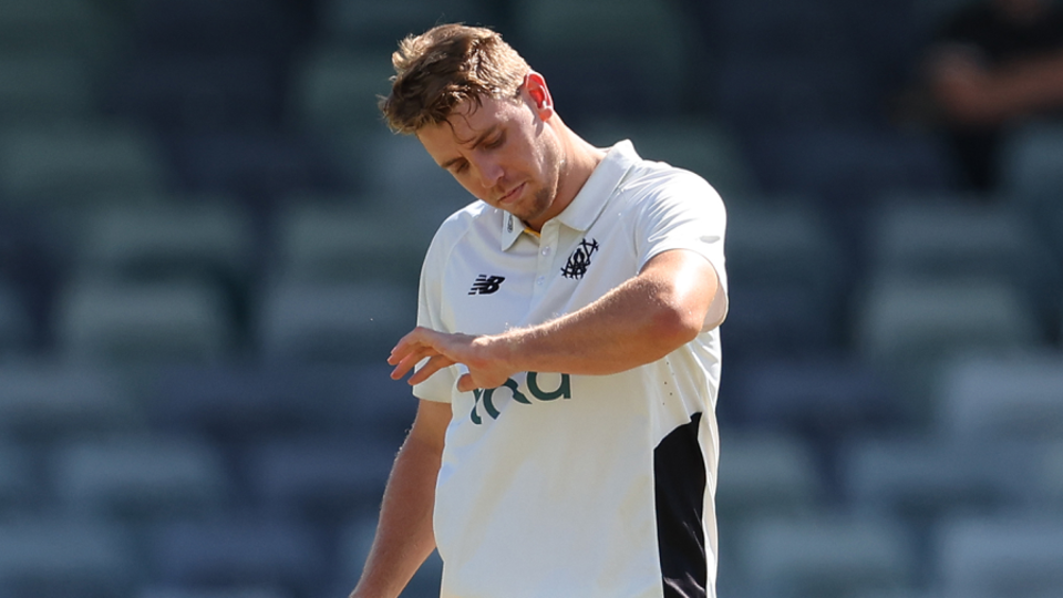 Cameron Green inspects his arm after a blow from Henry Thornton