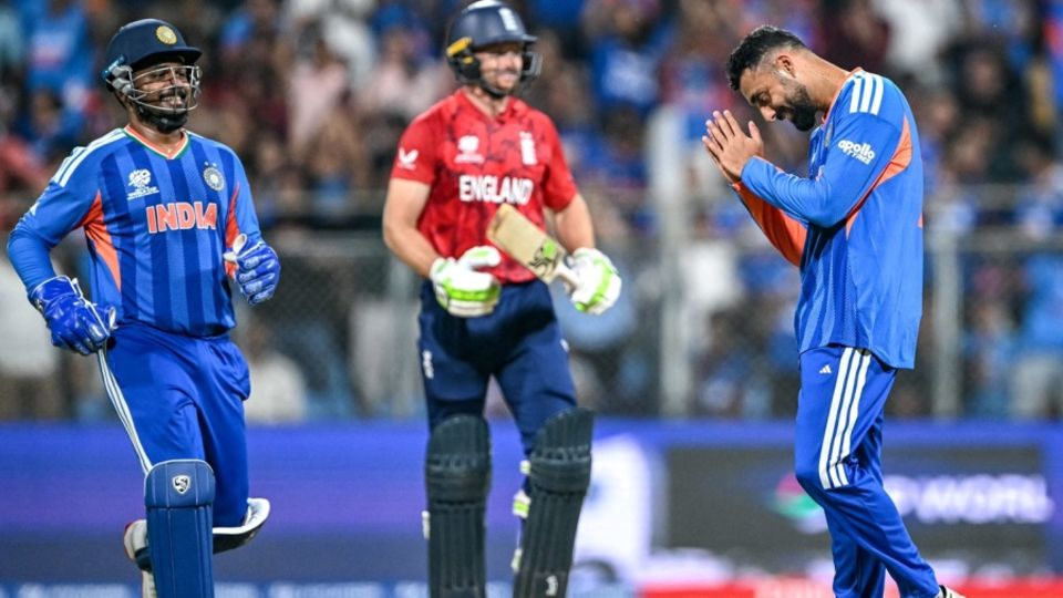 Varun Chakravarthy gestures to Sanju Samson after dismissing England's Jos Buttler