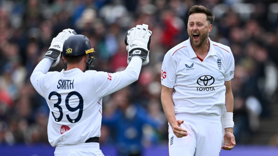 Ollie Robinson celebrates with Jamie Smith, under the helmet after standing up to the stumps