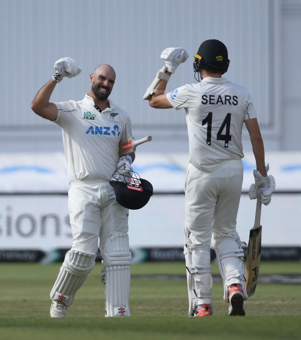 Daryl Mitchell celebrates with Ben Sears after his gutsy century