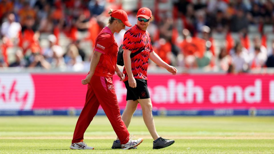 Sophie Devine leaves the field injured