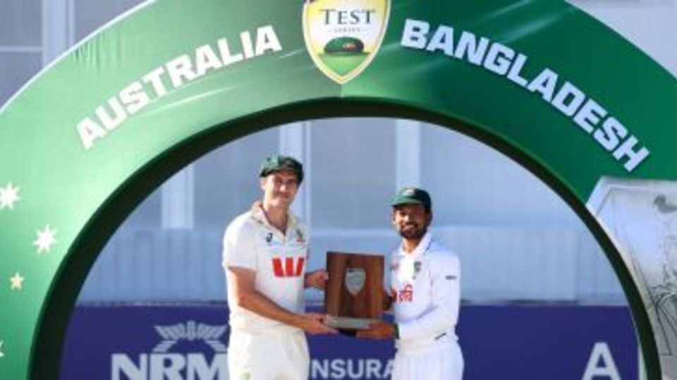 Pat Cummins and Najmul Hossain Shanto pose with the trophy after 1-1 series draw