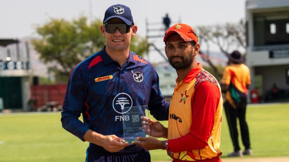Gerhard Erasmus of Namibia and Sikandar Raza of Zimbabwe at the toss