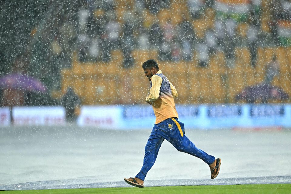 Shower to cover: ground staff sprint to save the pitch from the rain