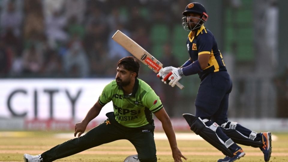 Kusal Mendis plays a shot as Haris Rauf takes a tumble