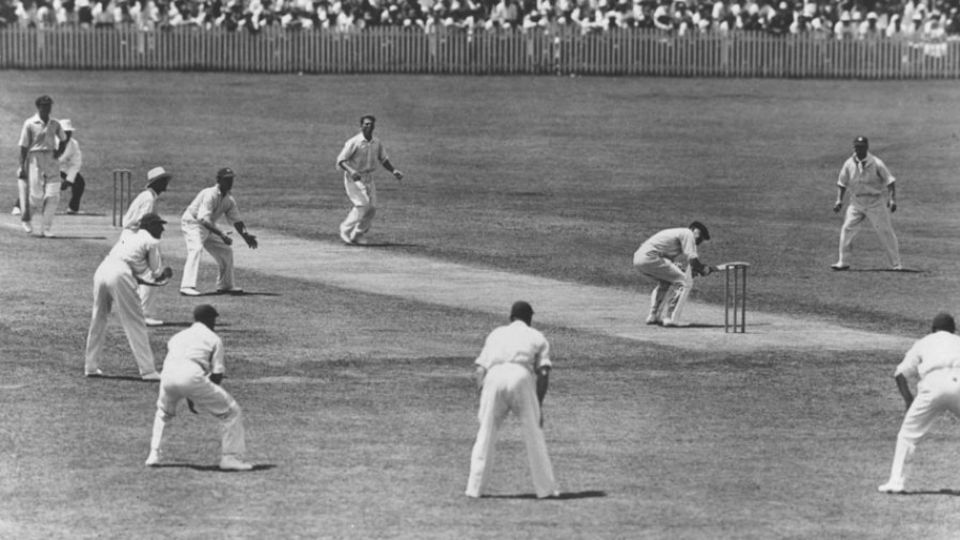 Probably the classic Bodyline photo: Bill Woodfull ducks a ball from Harold Larwood in Adelaide. The ring of close fielders are there to catch the ball as the batsman fends it away from his body, with more in the deep. At times there were only two on the off side