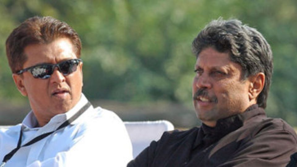 Kiran More and Kapil Dev watch the play-off for fifth place