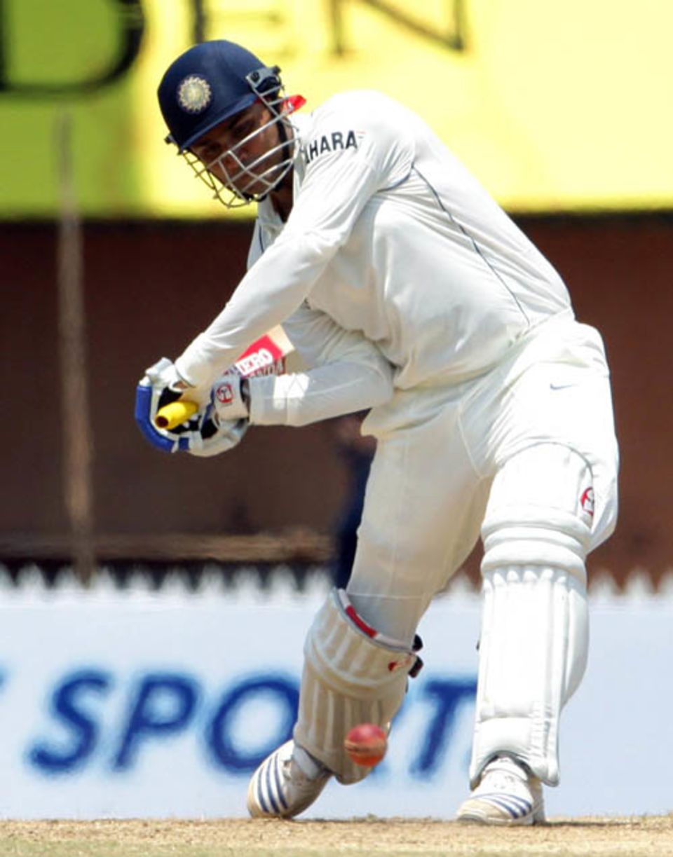 Virender Sehwag readies to bludgeon the ball