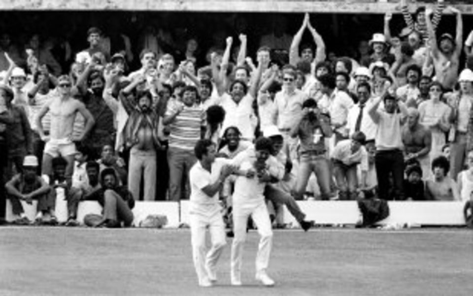 A couple of spectators get physical with their approval after the catch