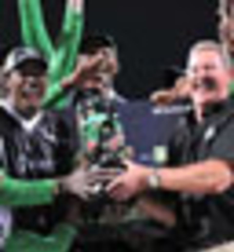 Allen Stanford presents the trophy to his Superstars team