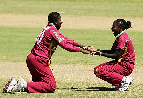 Pamela Lavine and Shakera Selman celebrate Claire Taylor's wicket