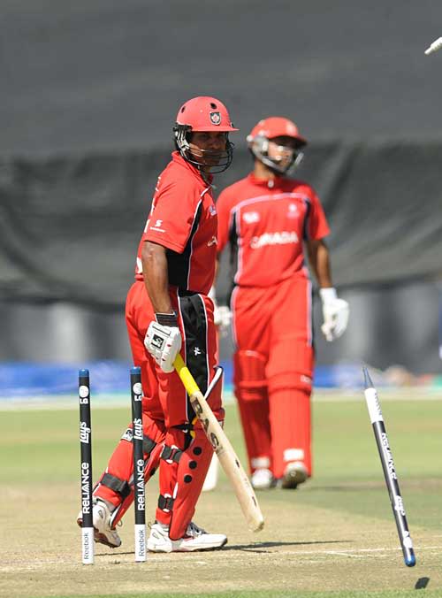 Sunil Dhaniram watches his stumps fly as he is bowled for 41