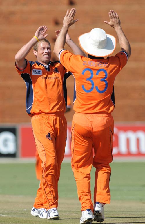 Edgar Schiferli is congratulated by Bas Zuiderent on taking a wicket