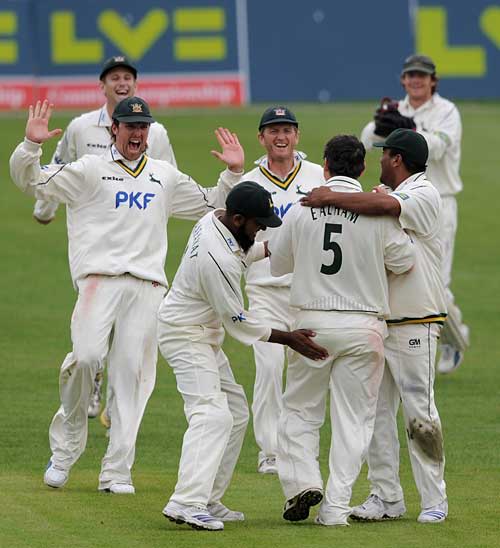 Mark Ealham is congratulated after removing Daryl Mitchell