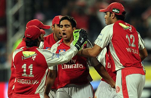 Team-mates mob Vikramjeet Malik after he sent back Sachin Tendulkar