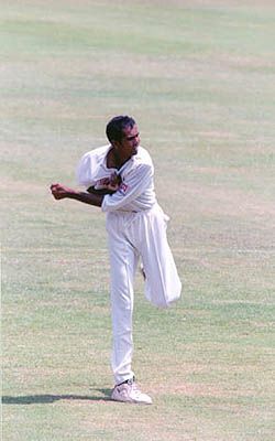 Nilesh Kulkarni warms up before having a bowl