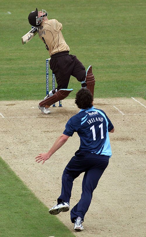Michael Brown has a swipe and Anthony Ireland prepares to take the return catch