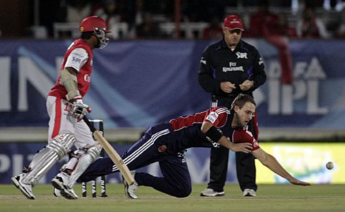 Daniel Vettori fields off his own bowling as Kumar Sangakkara looks on