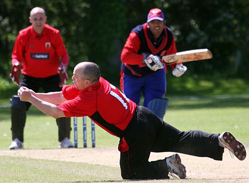 Rex Purnell takes a catch off his own bowling to dismiss Zaheer Zafar