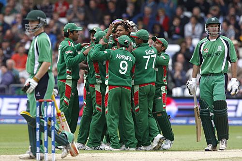 Team-mates mob Mashrafe Mortaza after the fall of Jeremy Bray's wicket