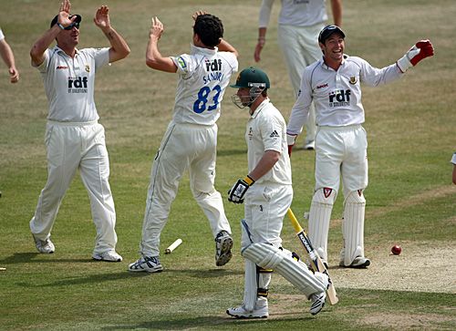 Pepler Sandri is congratulated on the wicket of Phil Hughes
