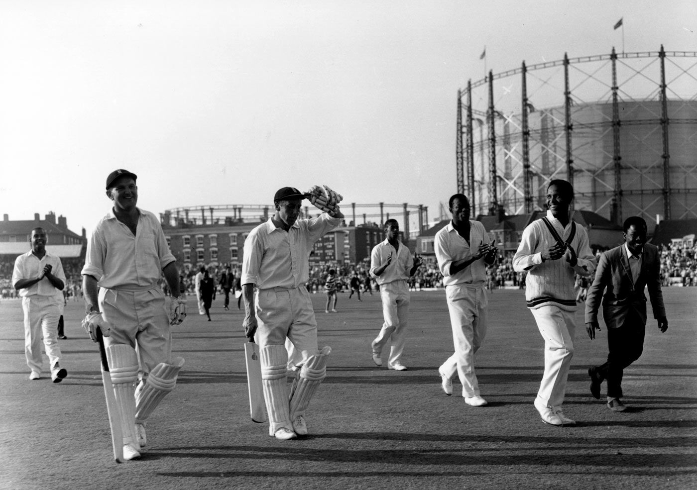 Tom Graveney (left) and John Murray leave the field