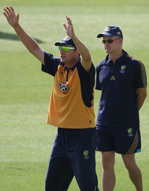 On-duty selector Jamie Cox keeps an eye on Stuart Clark at training