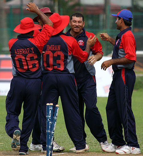 Halal Abbasi is congratulated for a wicket