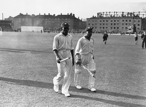 Manny Martindale and Derek Sealy leave the field at the end of the Test
