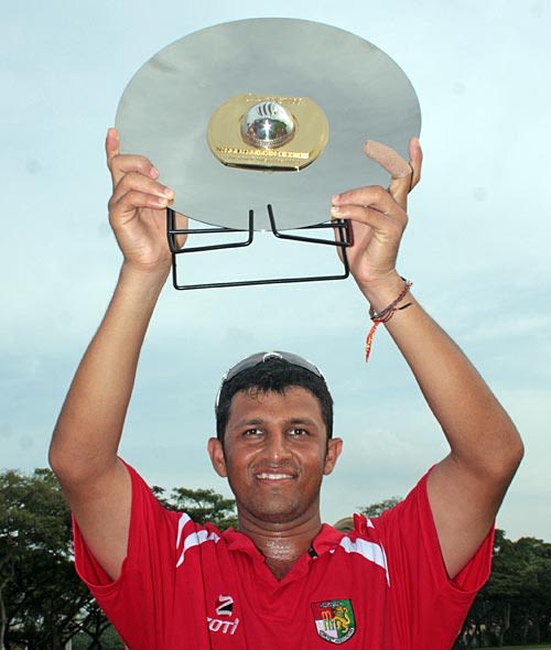 Chetan Suryawanshi, the Singapore captain, with the trophy