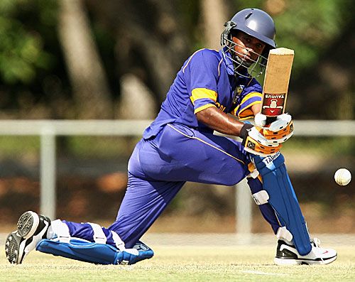 Rumesh Buddika sweeps during his 57