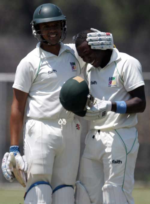 Ed Rainsford congratulates Vusi Sibanda on his double hundred
