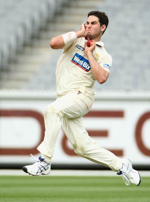 Scott Walter runs in to bowl