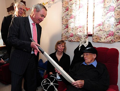 Eric Tindill, the oldest Test cricketer, is presented a signed bat