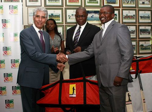 Mashonaland Eagles CEO, Hugo Ribatika accepts one of the kit bags from Shyam Bhatia while ZC Board Chairman Peter Chingoka looks on