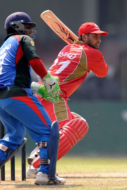 Abdool Samad plays through the off side as Mohammad Shahzad looks on 