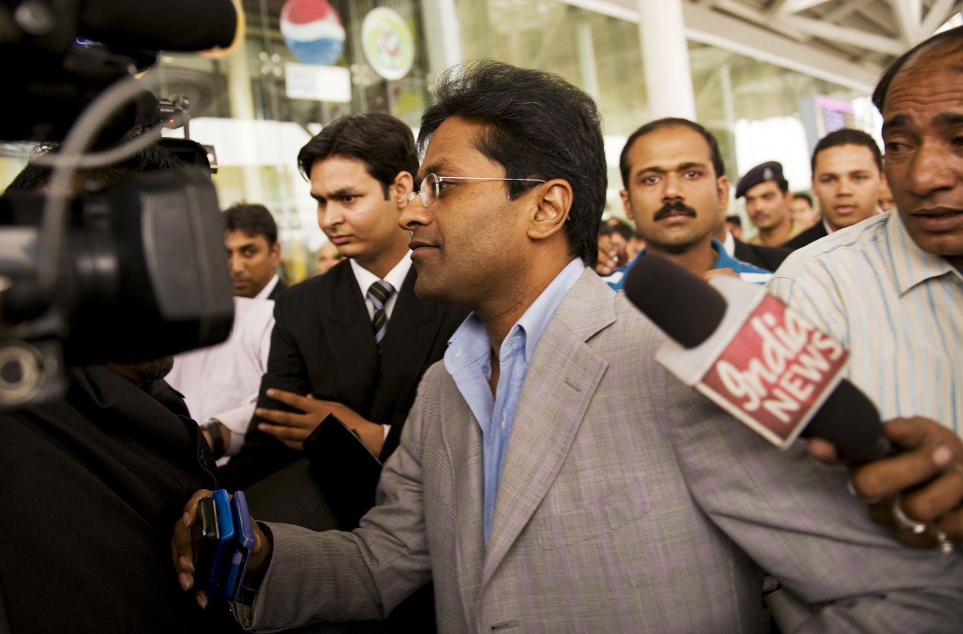 Lalit Modi arrives at the domestic terminal in New Delhi