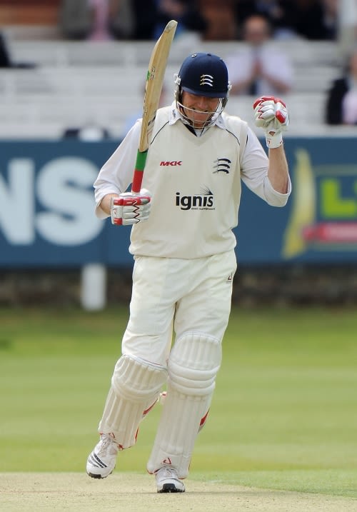 Shaun Udal punches the air after reaching his half century