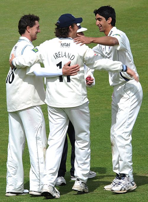 Gemaal Hussain is congratulated by his Gloucestershire team-mates as his five wickets helped them to victory 