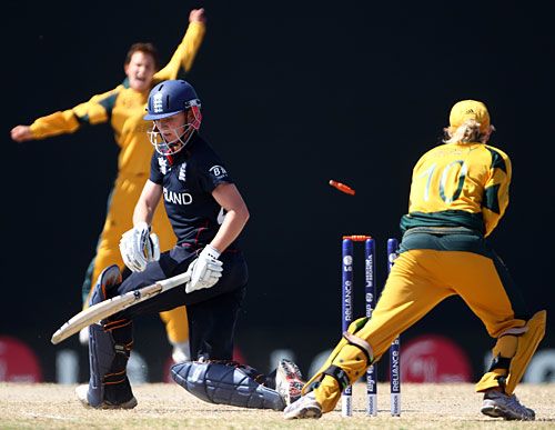 Beth Morgan of England is bowled by Shelley Nitschke as England's batting subsides