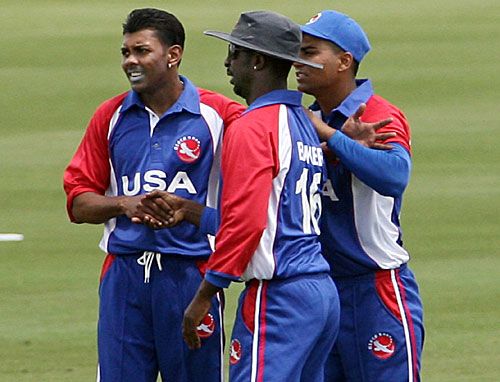 Orlando Baker is greeted by Steve Massiah and Asad Ghous after taking a catch