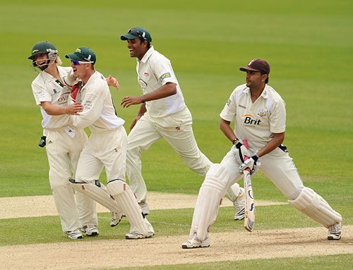 Leicestershire celebrate the dismissal of Usman Afzaal as Surrey slumped towards defeat