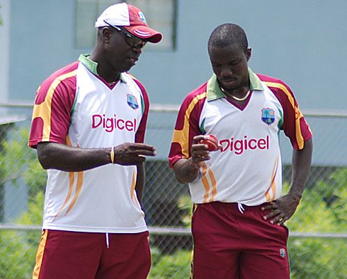 Nelon Pascal and Ottis Gibson share a word during practice