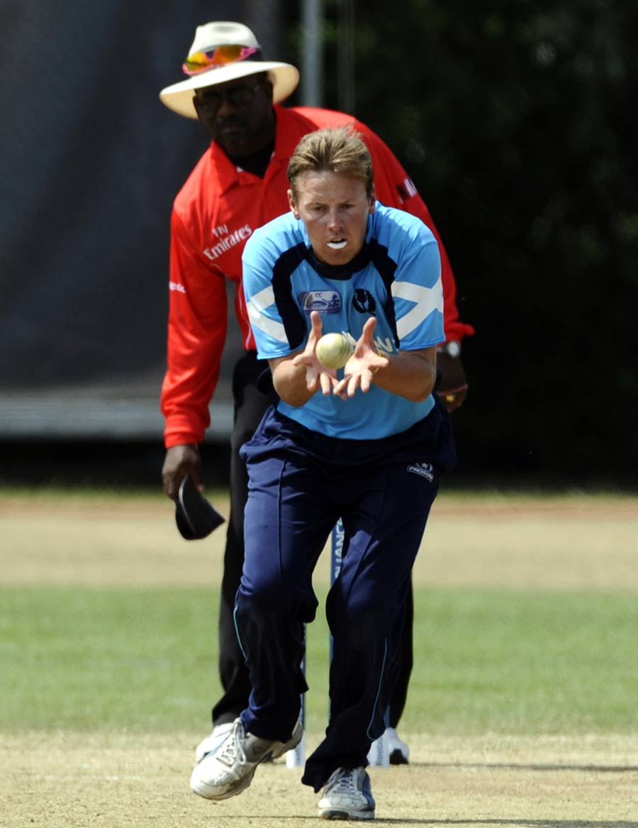 Ross Lyons of Scotland pouches a caught-and-bowled