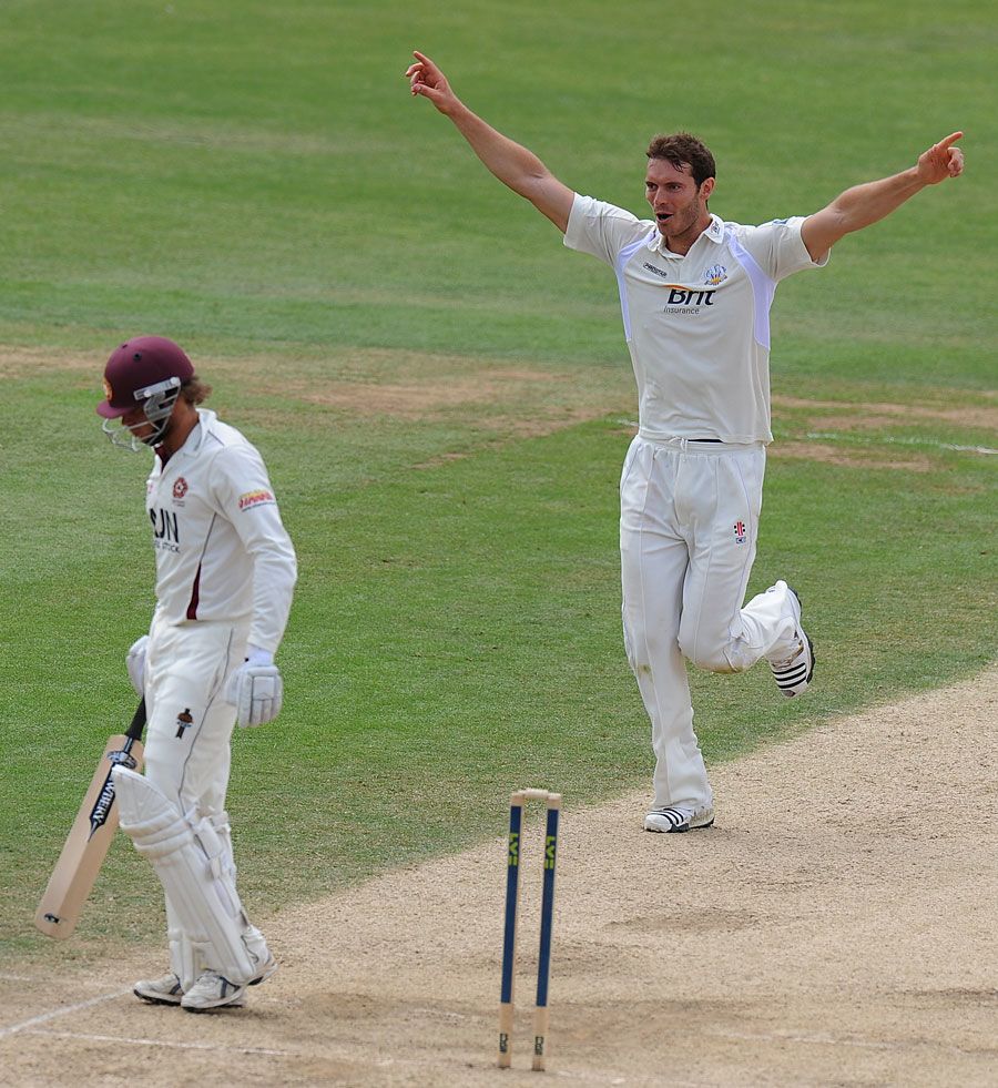 Chris Tremlett celebrates after uprooting Ben Howgego's off stump