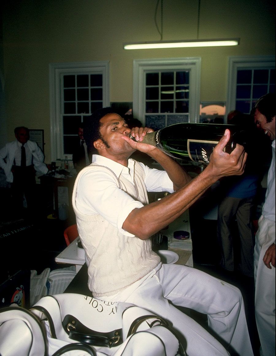 Norbert Phillips drinks champagne after a match