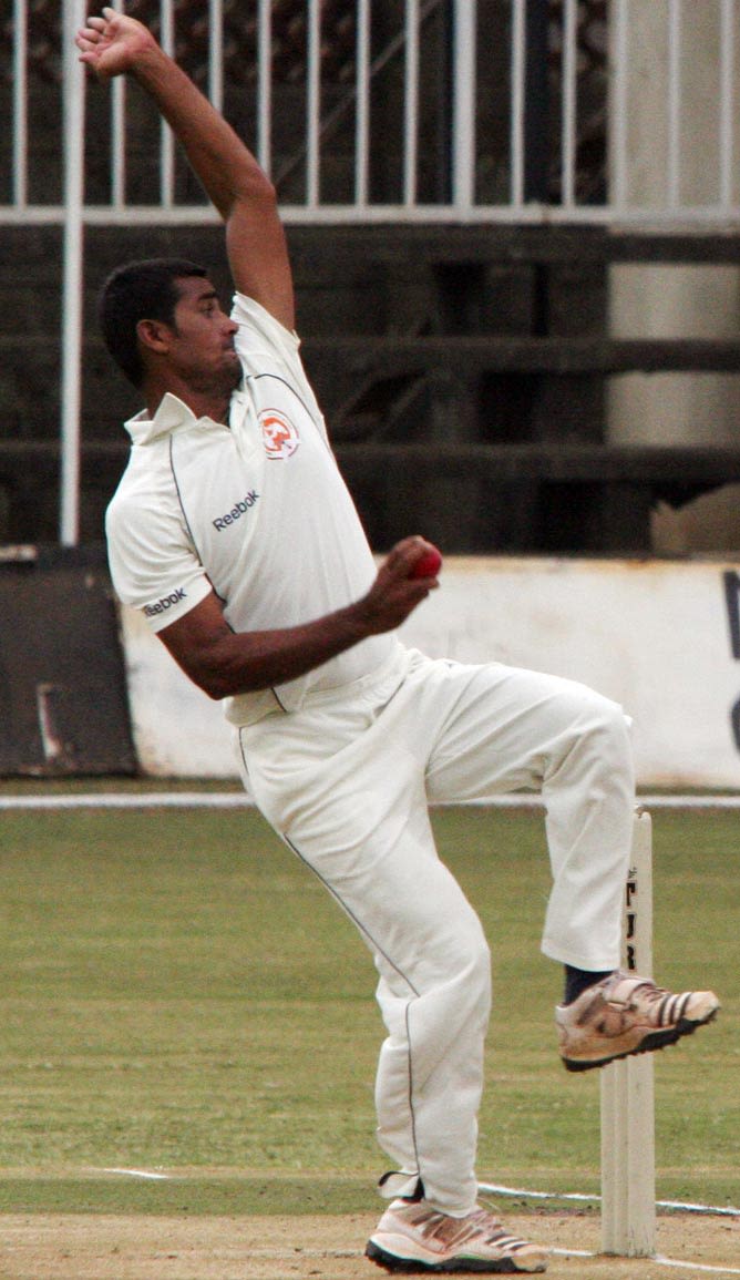 Baroda's Murtuja Vahora in his bowling stride