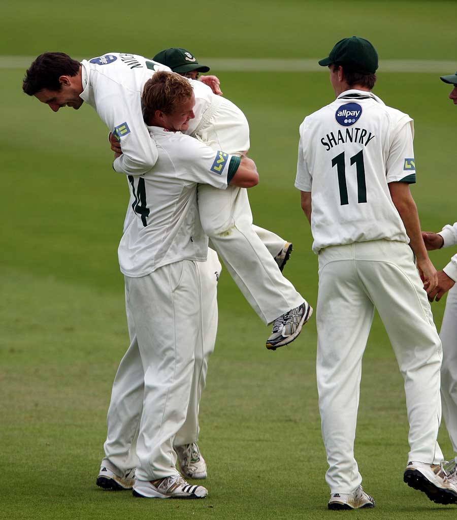Gareth Andrew lifts up Daryl Mitchell as they celebrate Rory Hamilton-Brown's dismissal