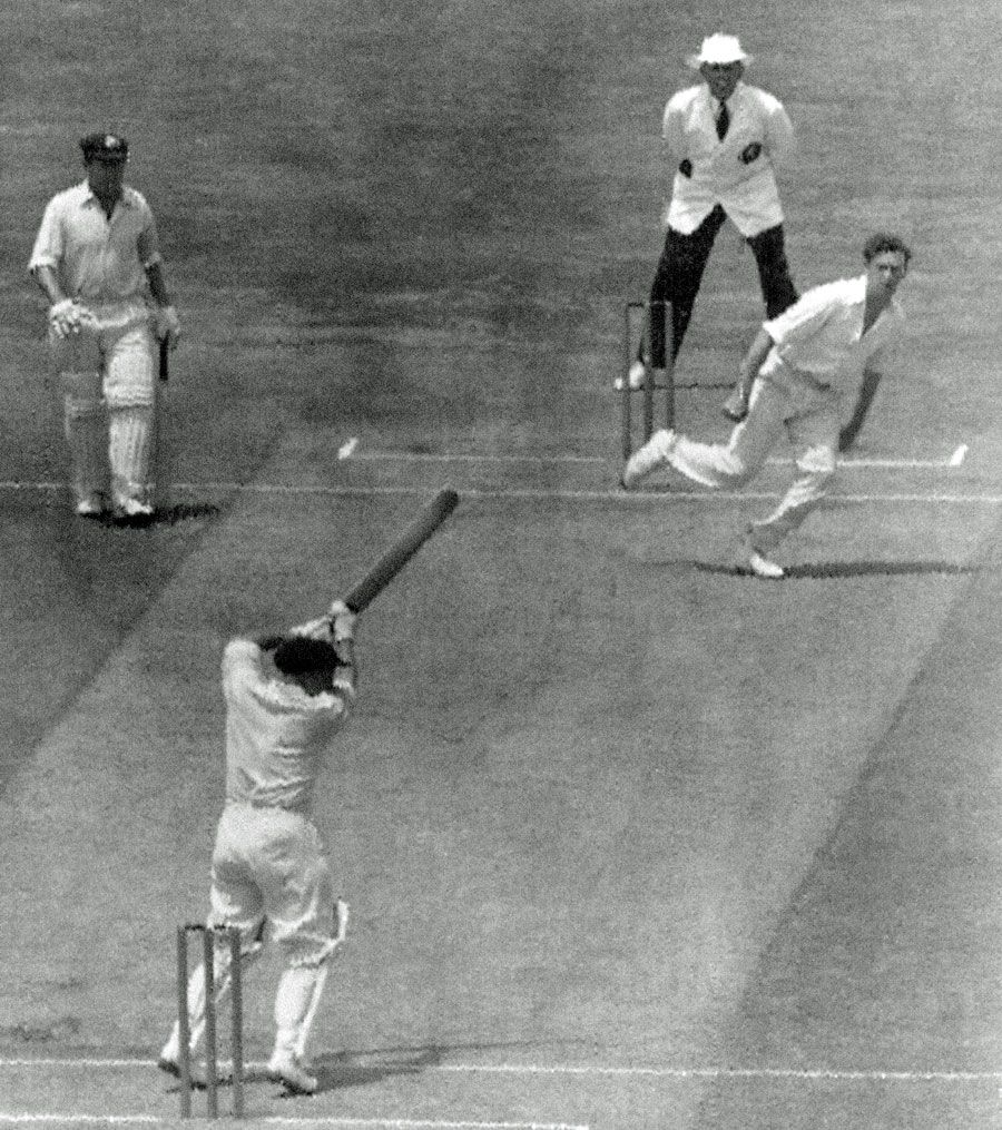 Les Favell cuts a ball Brian Statham as his team-mate Arthur Morris looks on